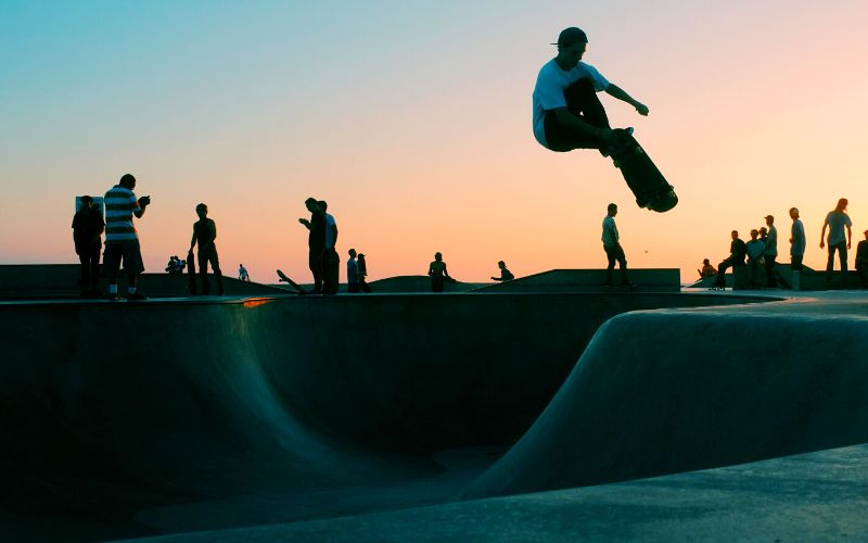 Skateboarder rides a half pipe with standard skateboard deck